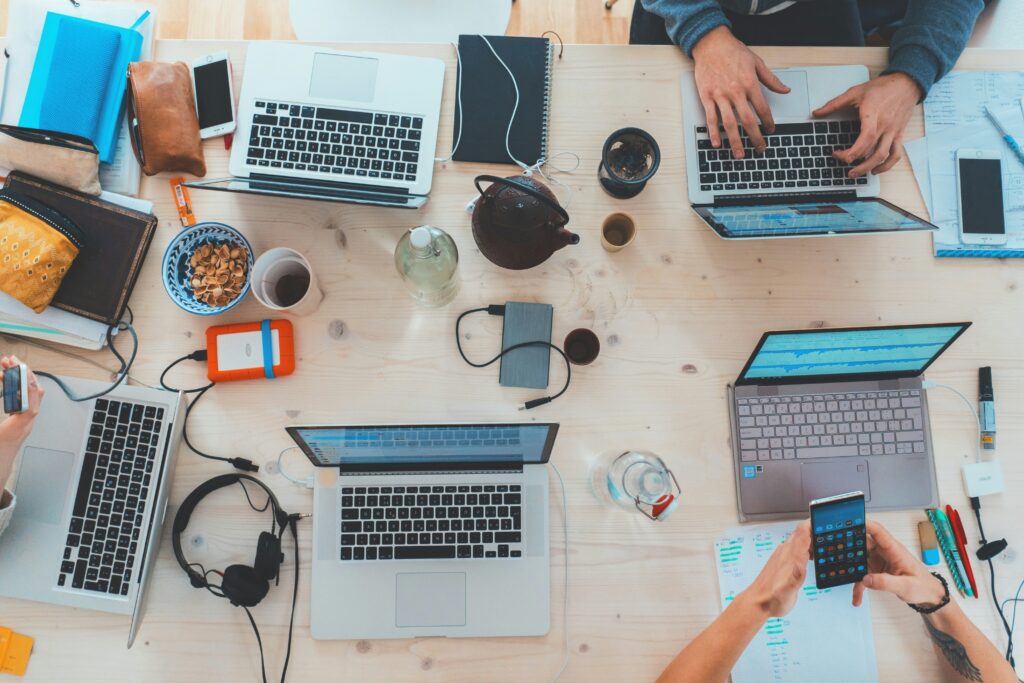 Start up environment with a lot of computers, technology, and coffee.