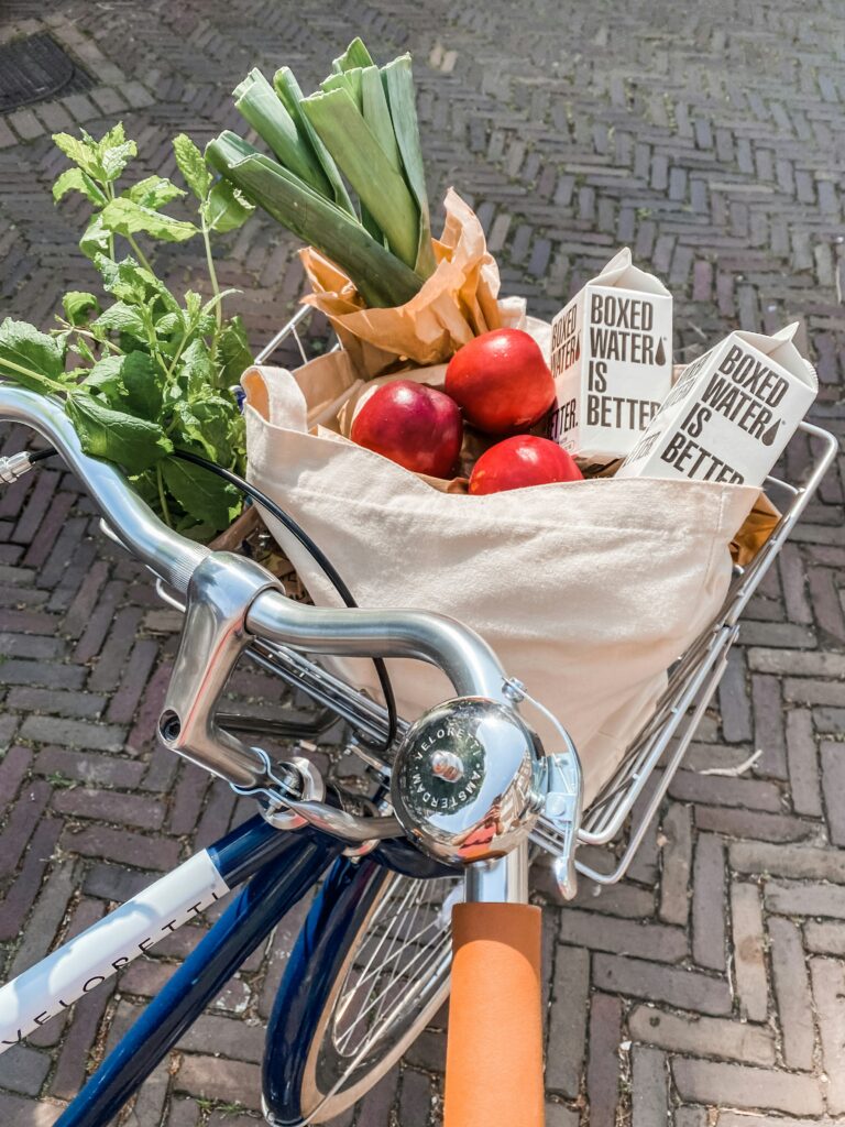 Sustainable groceries being delivered with reusable bags on a bike